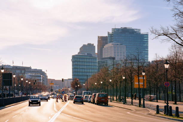 Street with car traffic and modern building architecture on Potsdamer Platz Square in City centre in Berlin in Germany in Europe. Building architecture. Details of exterior.