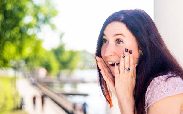 istock Surprised and happy caucasian woman outdoors looking away 1155988946