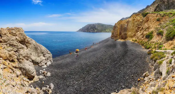 Beach view with black volcanic stones.