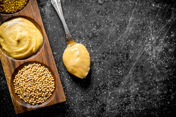istock Different mustard in the stand with a spoon. 1156007849