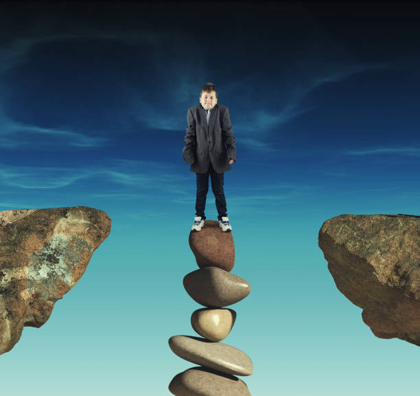 istock Businessman on a stack of stones in a gap between two rocks. 1156008395