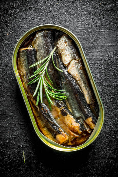 istock Sprats in a tin can of rosemary. 1156008845