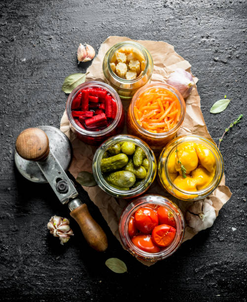 istock Jars of preserved vegetables on paper. 1156008961
