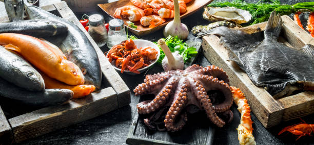 istock Sea fish on tray with octopus, herbs and garlic. 1156011593