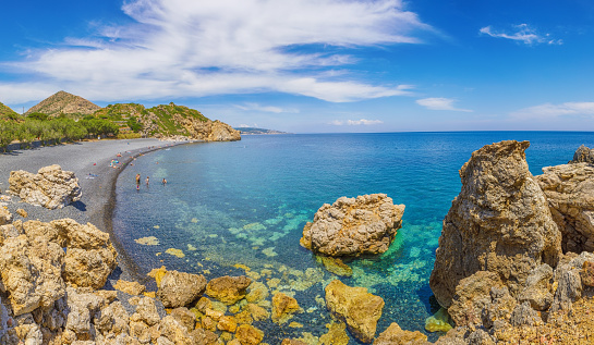 Beach view with black volcanic stones.