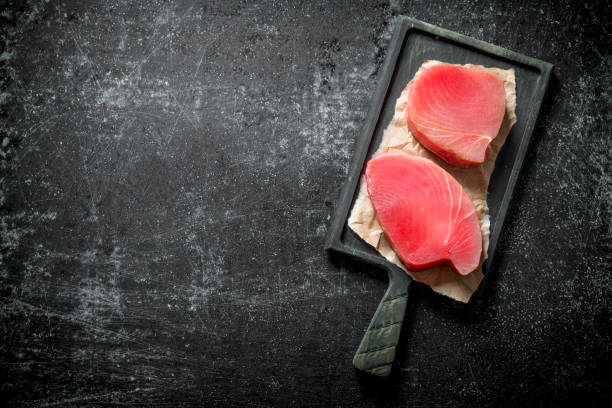 istock Raw tuna steak on cutting Board. 1156012081