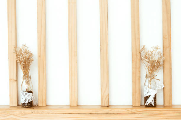 istock Drying flowers in a vase on the table with white wall background.instragram tone 1156012738