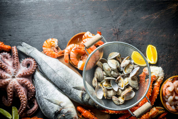 istock Seafood. Oysters, fresh fish, shrimp, octopus and crab with lemon slices. 1156012829