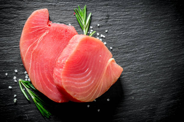 istock Fresh raw tuna steak with rosemary. 1156016511
