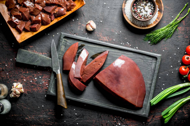 istock Sliced raw liver on a cutting Board with a knife. 1156016549