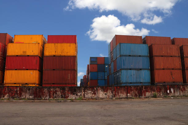 istock Shipping Containers placed as layered in the storage facility on blue sky background. 1156022198