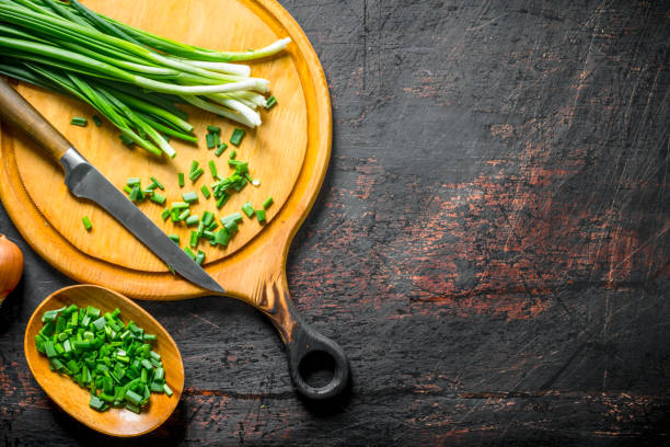 istock Chopped green onion on a cutting Board with a knife. 1156023283
