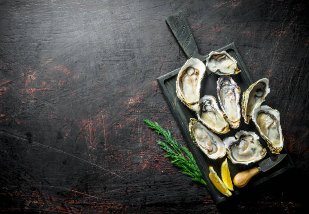 istock Fresh oysters on a cutting Board with dill and lemon. 1156023354