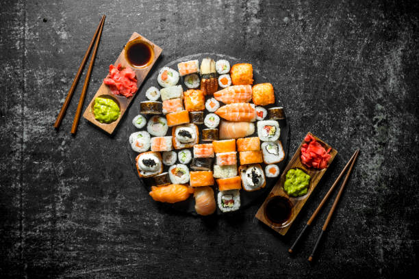 istock Delicious Japanese rolls with sauce and chopsticks. 1156024002