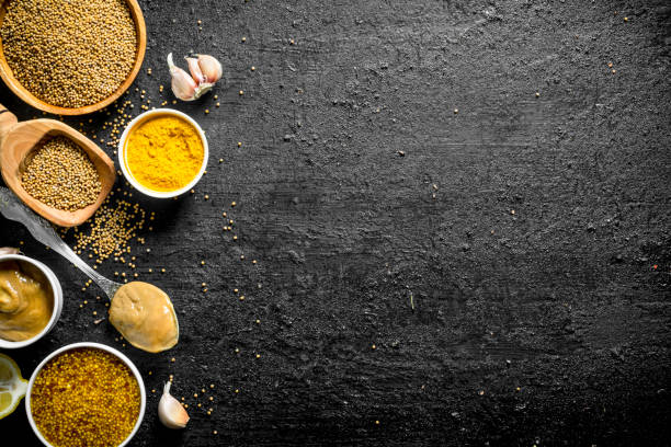 istock Different types of mustard with garlic cloves. 1156024054