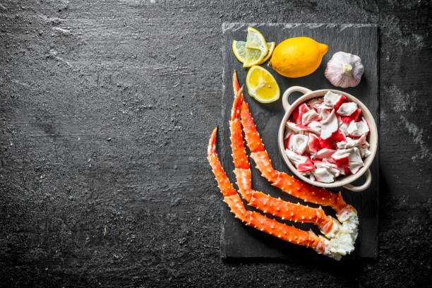 istock Crab meat and fresh crab on a stone Board with lemon and garlic. 1156024376