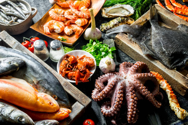 istock Sea fish on tray with octopus, herbs and garlic. 1156026524
