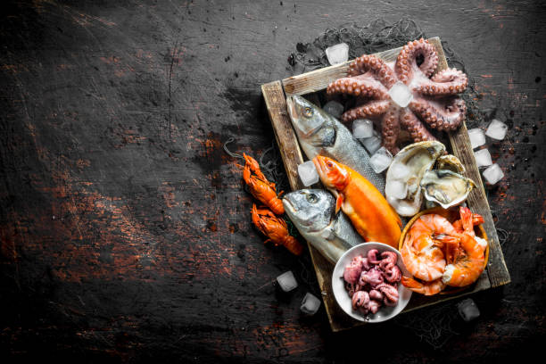 istock Assortment of different seafood on tray with ice cubes. 1156027767