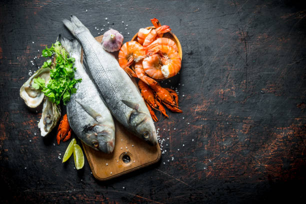 istock Fresh fish on a cutting Board with oysters, shrimp and crayfish. 1156029190