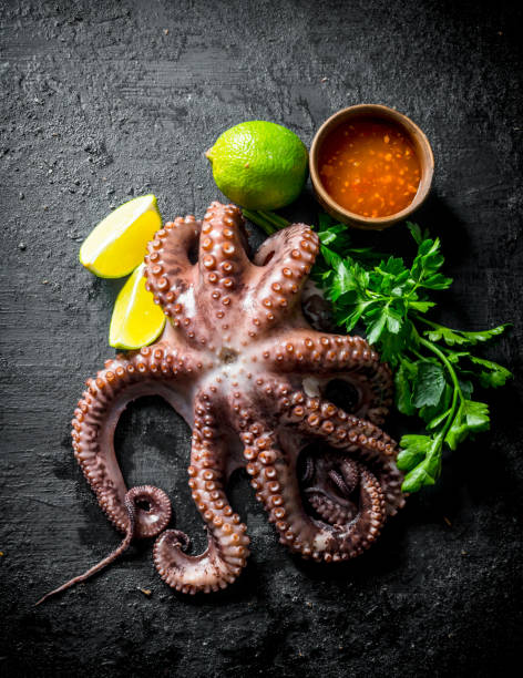 istock Fresh octopus with parsley, lime and sauce in bowl. 1156029252