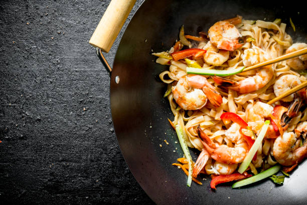 istock Fragrant Asian Udon noodles in a wok pan. 1156030837