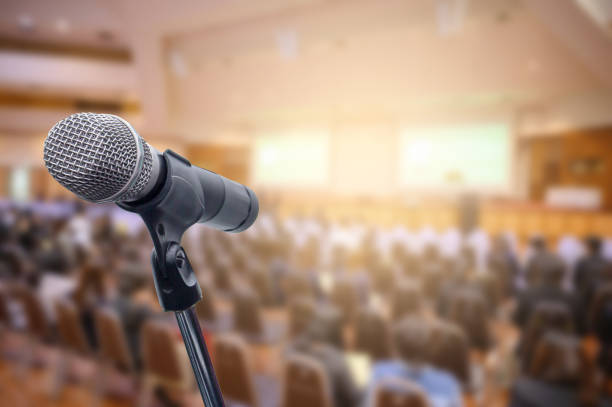 istock Microphone over the blurred business people forum Meeting Conference Training Learning Coaching Concept, Blurred background. 1156035319