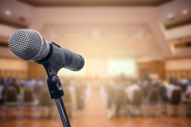 istock Microphone over the blurred business people forum Meeting Conference Training Learning Coaching Concept, Blurred background. 1156035321