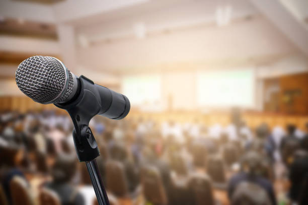 istock Microphone over the blurred business people forum Meeting Conference Training Learning Coaching Concept, Blurred background. 1156035338