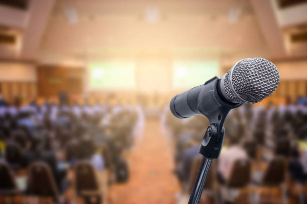 istock Microphone over the blurred business people forum Meeting Conference Training Learning Coaching Concept, Blurred background. 1156035339