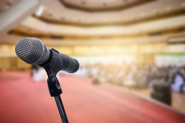 istock Microphone over the blurred business people forum Meeting Conference Training Learning Coaching Concept, Blurred background. 1156035347