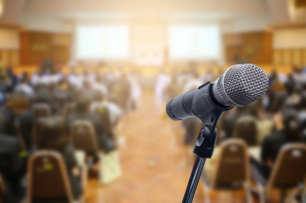 istock Microphone over the blurred business people forum Meeting Conference Training Learning Coaching Concept, Blurred background. 1156035350