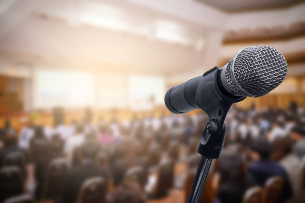 istock Microphone over the blurred business people forum Meeting Conference Training Learning Coaching Concept, Blurred background. 1156035354