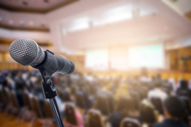istock Microphone over the blurred business people forum Meeting Conference Training Learning Coaching Concept, Blurred background. 1156035356
