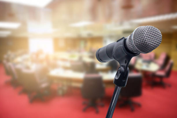istock Microphone over the blurred business people forum Meeting Conference Training Learning Coaching Concept, Blurred background. 1156035362