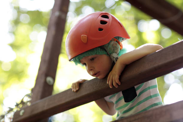 Child climber on a wooden bridge in the park