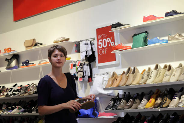 istock Woman in a shoe store 1156036440