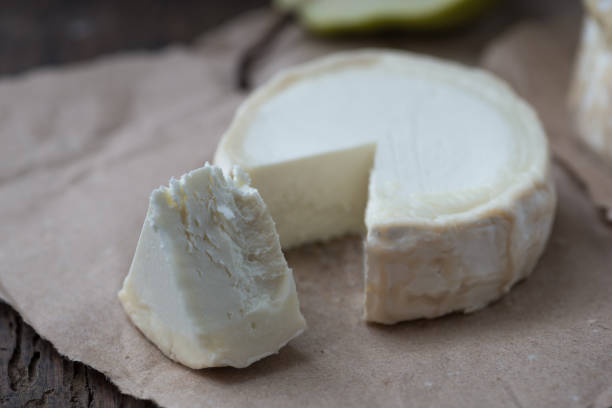 istock Piece smelly camembert cheese on a wooden rustic table 1156037817