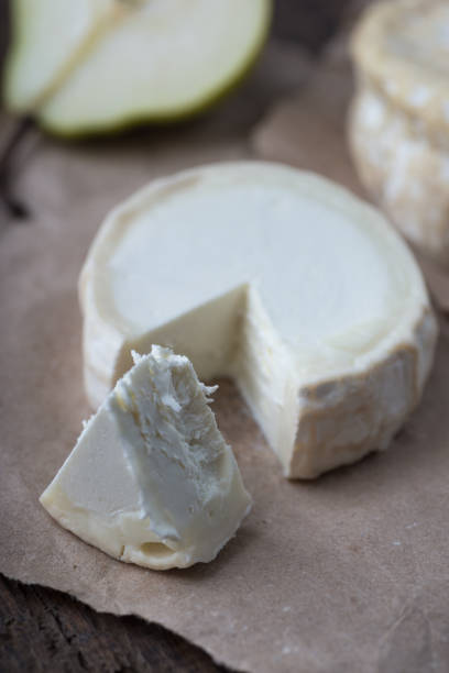 istock Piece smelly camembert cheese on a wooden rustic table 1156037829
