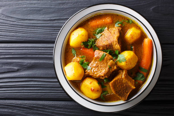 Namibia Potjiekos traditional lamb dish with vegetables close-up in a bowl. Horizontal top view Namibia Potjiekos traditional lamb dish with vegetables close-up in a bowl on the table. horizontal top view from above african culture food stock pictures, royalty-free photos & images