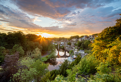 Classic summer sunset view of the railway viaduct over the river Nidd valley in the market town of Knaresborough in North Yorkshire England