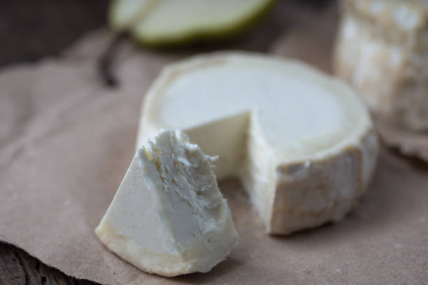 istock Piece smelly camembert cheese on a wooden rustic table 1156039110