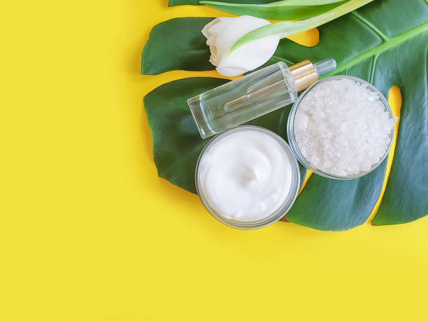 istock cream cosmetic tulip, monstera on a colored background 1156040202