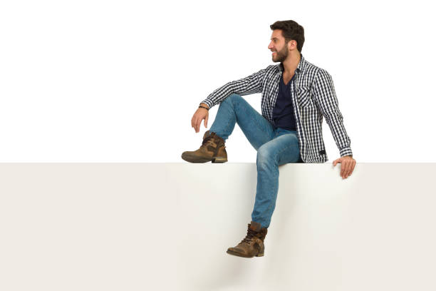istock Handsome Man Is Sitting Relaxed On A Top And Looking Away 1156041812