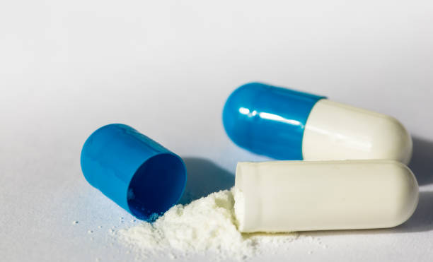 istock macro view of blue Capsule with white powder 1156041825