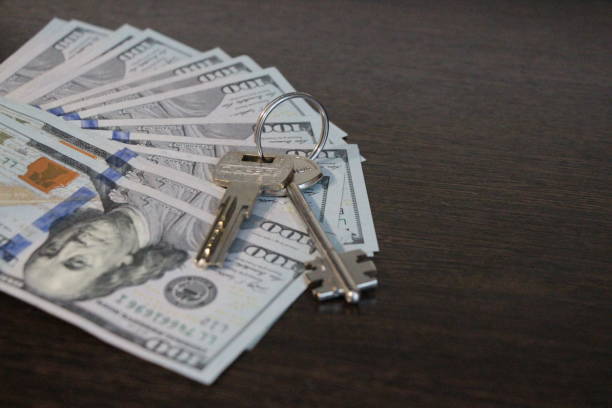 istock The keys lies on the hundred-dollar bills. 1156043892