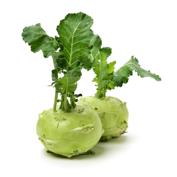 istock Fresh kohlrabi with green leaves on isolated white backround 1156044185