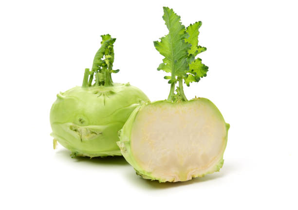 istock Fresh kohlrabi with green leaves on isolated white backround 1156044187