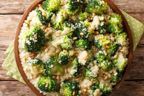istock Vegetarian broccoli meal with quinoa and pine nuts closeup on a plate. Horizontal top view 1156046131