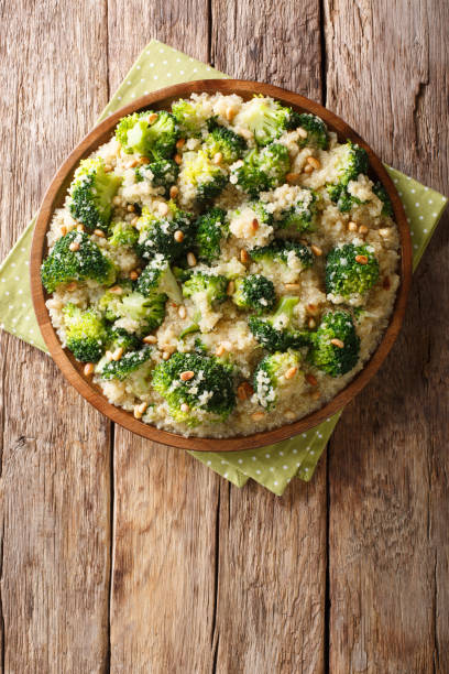 istock Broccoli salad with quinoa and pine nuts close-up on a plate. Vertical top view 1156046193