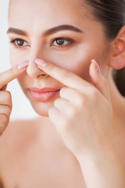 istock Problem Skin. Woman Crushing Spot On Face And Looking In Mirror 1156050155